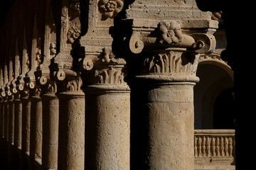 lights and shadows on ancient columns in monastery cloister