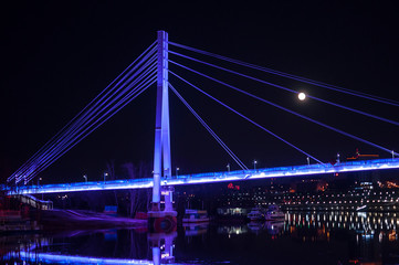 Fototapeta na wymiar Tyumen, Russia, on April 15, 2020: The pedestrian cable-stayed bridge in Tyumen at night