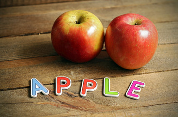 Pair of red apples on wood