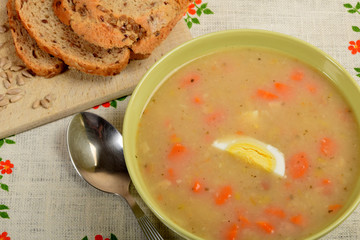 white sour soup with sausage, egg and bread