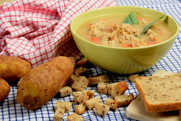 home made potato soup in a bowl with pieces of dry bread