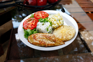 Grilled pork with fries and vegetables
