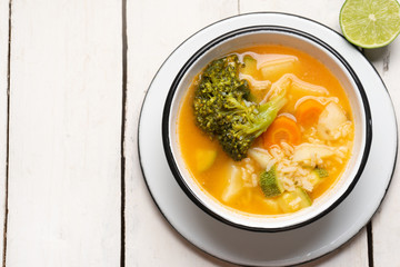 Vegetables soup with rice on white background