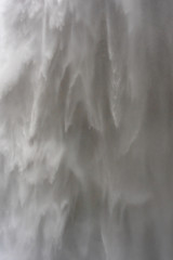Image of water rushing down a waterfall on a dark background