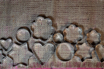 Fototapeta na wymiar A variety of cookie shapes are laid out on jute fabric.