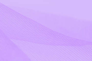 Light small mesh fabric on violet background. Shades of violet