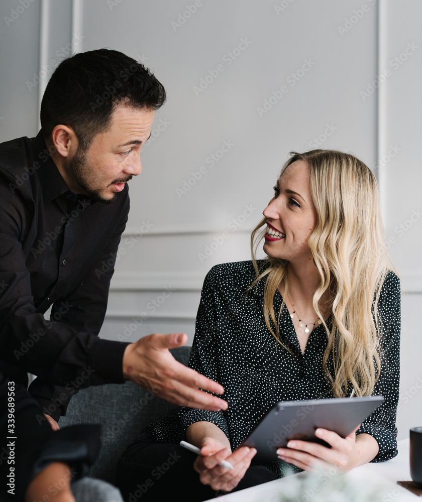 Wall mural Coworkers talking to each other