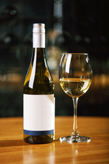 A bottle of wine and glasses on the table, against the background of a wine shakafa. Serving and serving wine. Winemaking concept, copy space.