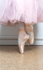 Legs of ballerina in ballet shoes, closeup. Distant training with, social distance or self-isolation, online education concept.