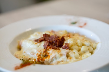 Side  view of macaroni and cheese top with bacon.
