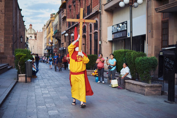 A mysterious and solitary confrere performs The Procession Of Silence in the streets of downtown...
