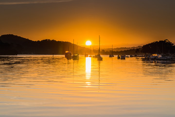 Fototapeta na wymiar Golden Sunrise over the Bay