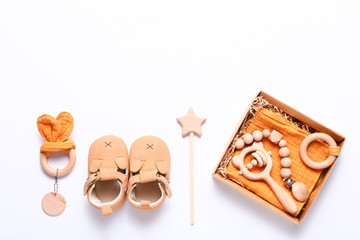 Set of baby shoes, toys and accessories on white background. Newborn stuff. Flat lay, top view