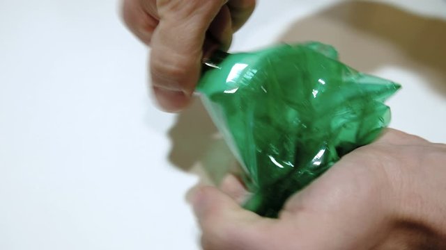 Man crushing plastic bottle for separate garbage collection,recycle concept