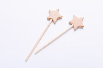 Wooden baby toys on white background. Two wooden stars. Eco accessories for newborn.