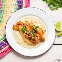 Mexican breaded fish tacos also called ensenada on white background