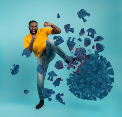 Man attacks with a kick the coronavirus. Blue background