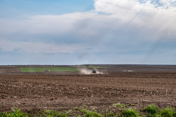 Tractor ploughing(plowing) field in early spring