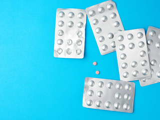 round pills in blister packs on a blue background