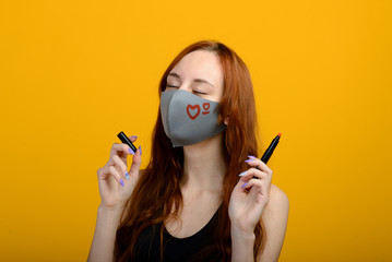 Portrait of a girl in a mask, which puts on a rubber glove. Yellow background.