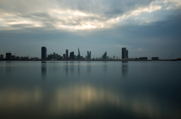 Bahrain skyline with beautiful clouds and reflection on water