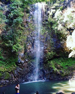 People Enjoying In Waterfall At Kauai