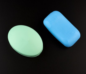 blue and green soaps on a black background