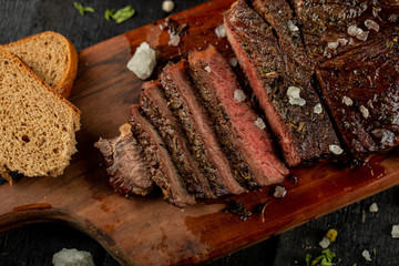 Sliced meat barbecue served with onion and sea salt, top view