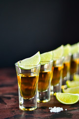 five glasses of alcohol and lime and red chili, a party at the bar, a menu for the bar. Selective focus and copy space, Tequila shots, vodka, whisky, rum
