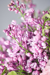 Closeup of lilac flowers. Spring bouquet in a wicker basket.. Learning flower arranging, making beautiful bouquets with your own hands. Flowers delivery