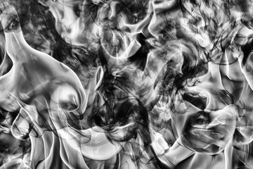 Abstract black smoke natural black smoke and white huge flame of strong fire. Dangerous firestorm abstract texture. Motion blur from fire, high temperature from flames. Dramatic black and white image.