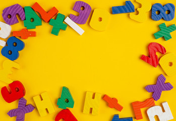 Wooden toy figures on a yellow background.