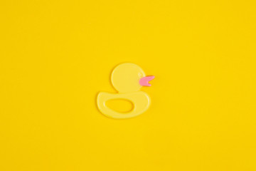 Rubber duck on yellow background.