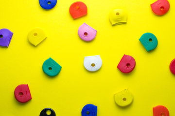 colorful rubber key covers on a yellow background