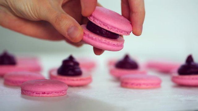 Process of making macaron macaroon, french dessert, squeezing the dough form cooking bag