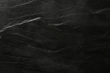 Dark grey and black slate background or texture. Flat lay top view copy space.