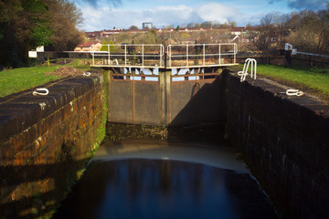 A lock gate on the Forth and Clyde canal in the early morning on a spring day