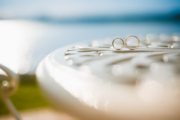 Wedding rings laying on the table. Close up photo
