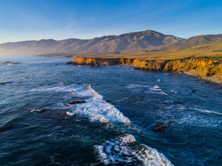 Aerial view of headlands and breaking surf along Big Sur Coast, California