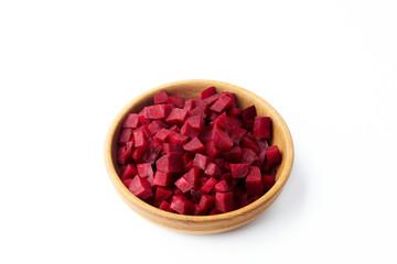 Sliced raw beets in a wooden bowl isolated on a white background.