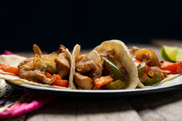 Mexican chicken fajitas tacos on wooden background
