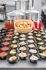 Food delivery. Different in plastic disposable lunch box with healthy natural food. Chicken broth, mashed soup, mashed potatoes with cutlet, seafood pasta, salads, pilaf with a fresh bun.