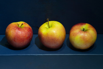 some red apples on a blue background.