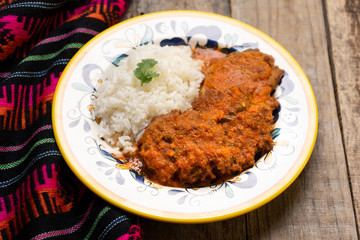 Mexican tuna patties also called "tortitas" and rice on wooden background