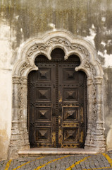 Wood carved door with stone work, lateral entrance of Elvas main church