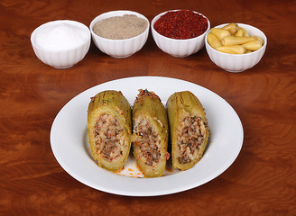 very nice stuffed zucchini stuffed in white plate, spicy turkish spicy on wooden table