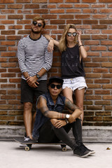 company of friends of skaters on the background of a brick wall.