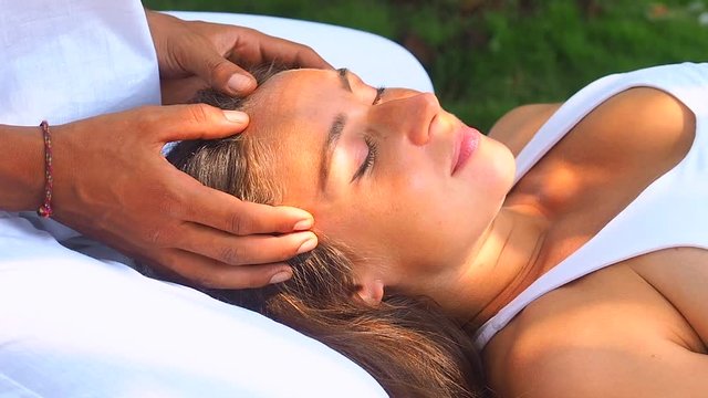 woman getting sensuality massage from her husband outdoor tropical beach resort garden