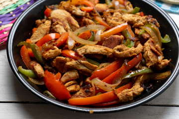 Mexican chicken fajitas on white background