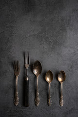 antique cutlery on dark wooden background